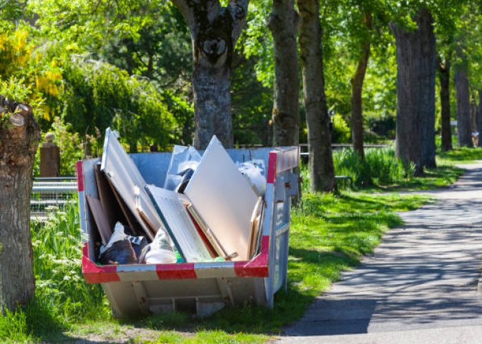 skip with renovation waste under trees in rotterdam in the netherlands